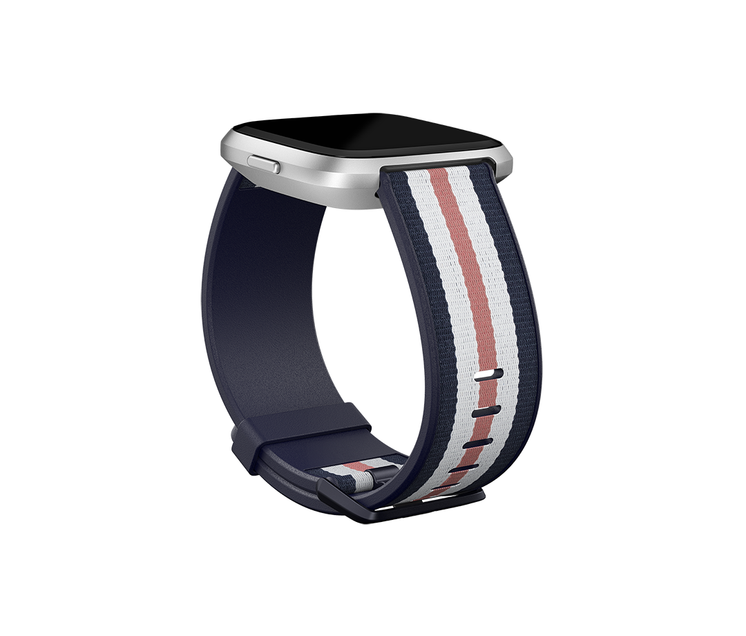 Fitbit  Versa-Lite Woven Hybrid Band, large, navy/pink The Fitbit Versa woven hybrid band is made of polyester woven material on top and fluoroelastomer material on the bottom with an aluminium buckle. The Fitbit Versa woven hybrid band is not water resis